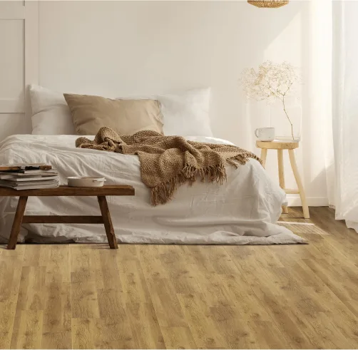 A cozy room scene featuring EF Timberstep Hard Surface flooring in a bedroom